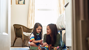 A woman and child playing with clean toys